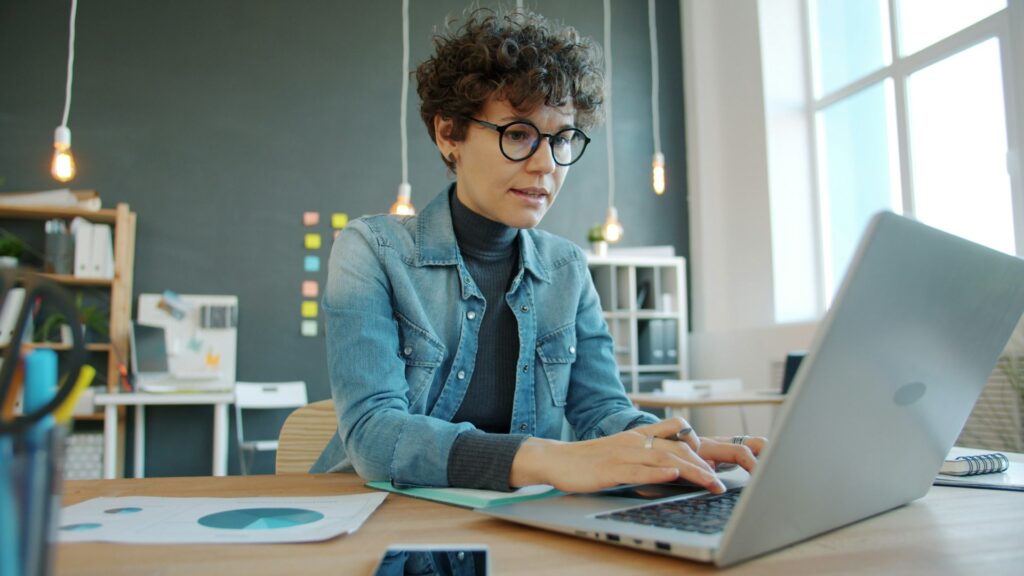 Professional working on a laptop in a modern office